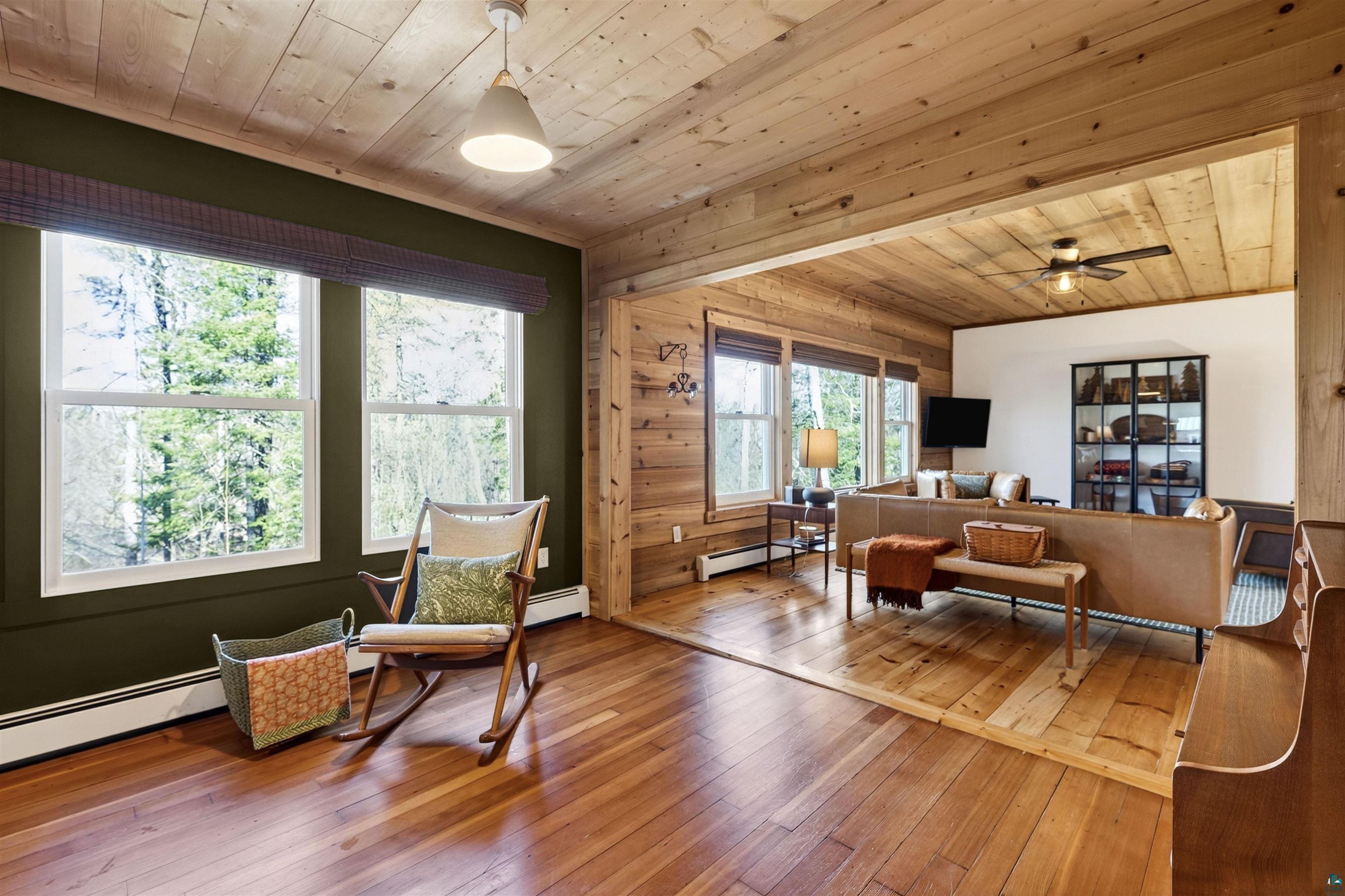 13885 Park Road Brule, WI 54820 - Photo 11 of 41 Rich wood-finish flooring extending through an open doorway, complemented by plank wood ceilings and walls