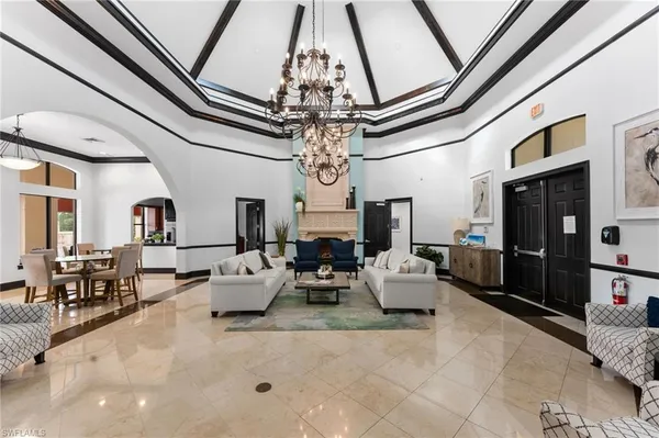 a living room with fireplace furniture and a chandelier