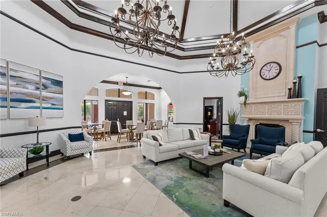 a living room with furniture a large window and a fireplace