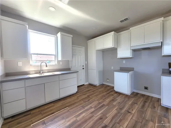 a spacious bathroom with a sink and a mirror