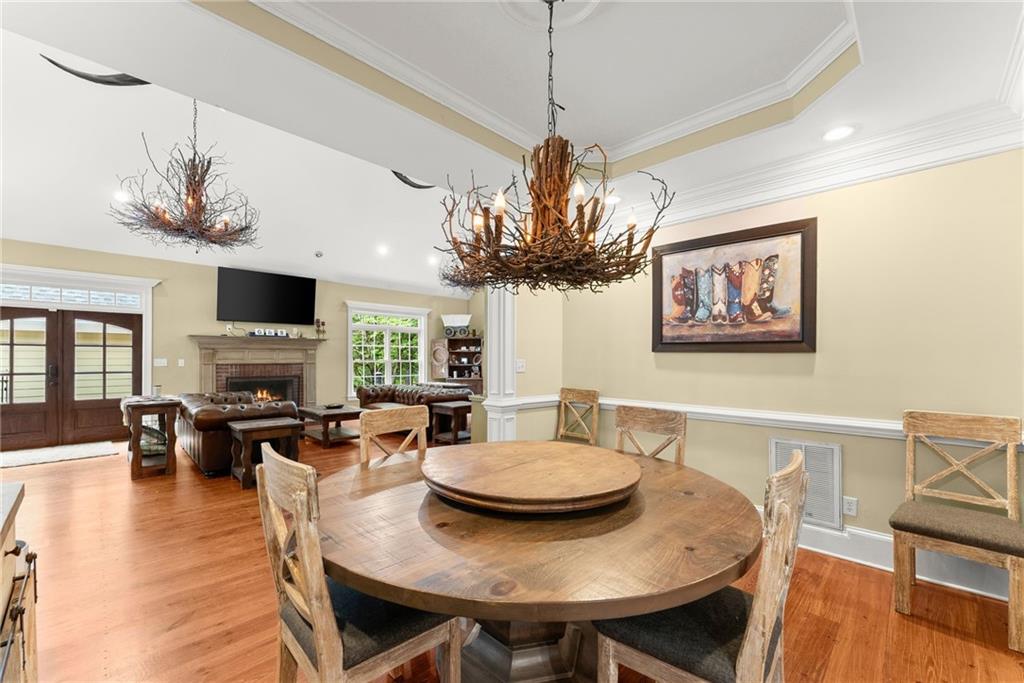 2832 B B Wilson Road Commerce, GA 30529 - Photo 12 of 96 a view of a dining room with furniture a chandelier and wooden floor