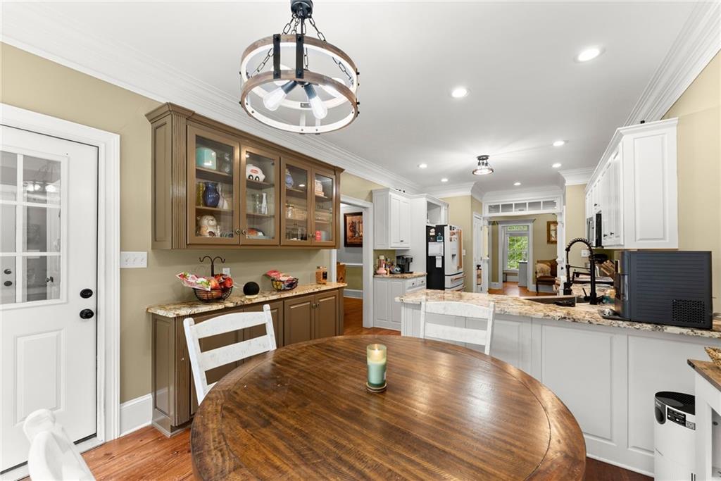 2832 B B Wilson Road Commerce, GA 30529 - Photo 17 of 96 a large white kitchen with lots of counter space wooden floor and stainless steel appliances
