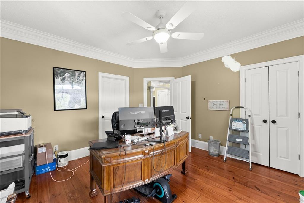 2832 B B Wilson Road Commerce, GA 30529 - Photo 20 of 96 a view of a workspace with furniture and wooden floor