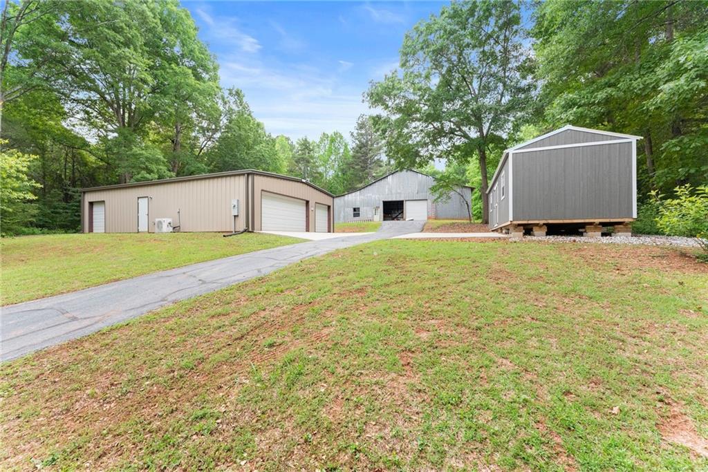 2832 B B Wilson Road Commerce, GA 30529 - Photo 61 of 96 a white house with a big yard and large trees