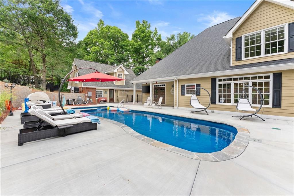 2832 B B Wilson Road Commerce, GA 30529 - Photo 68 of 96 a swimming pool view with a seating space and a garden view