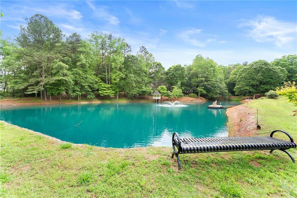 2832 B B Wilson Road Commerce, GA 30529 - Photo 74 of 96 a view of a lake with a yard and large trees