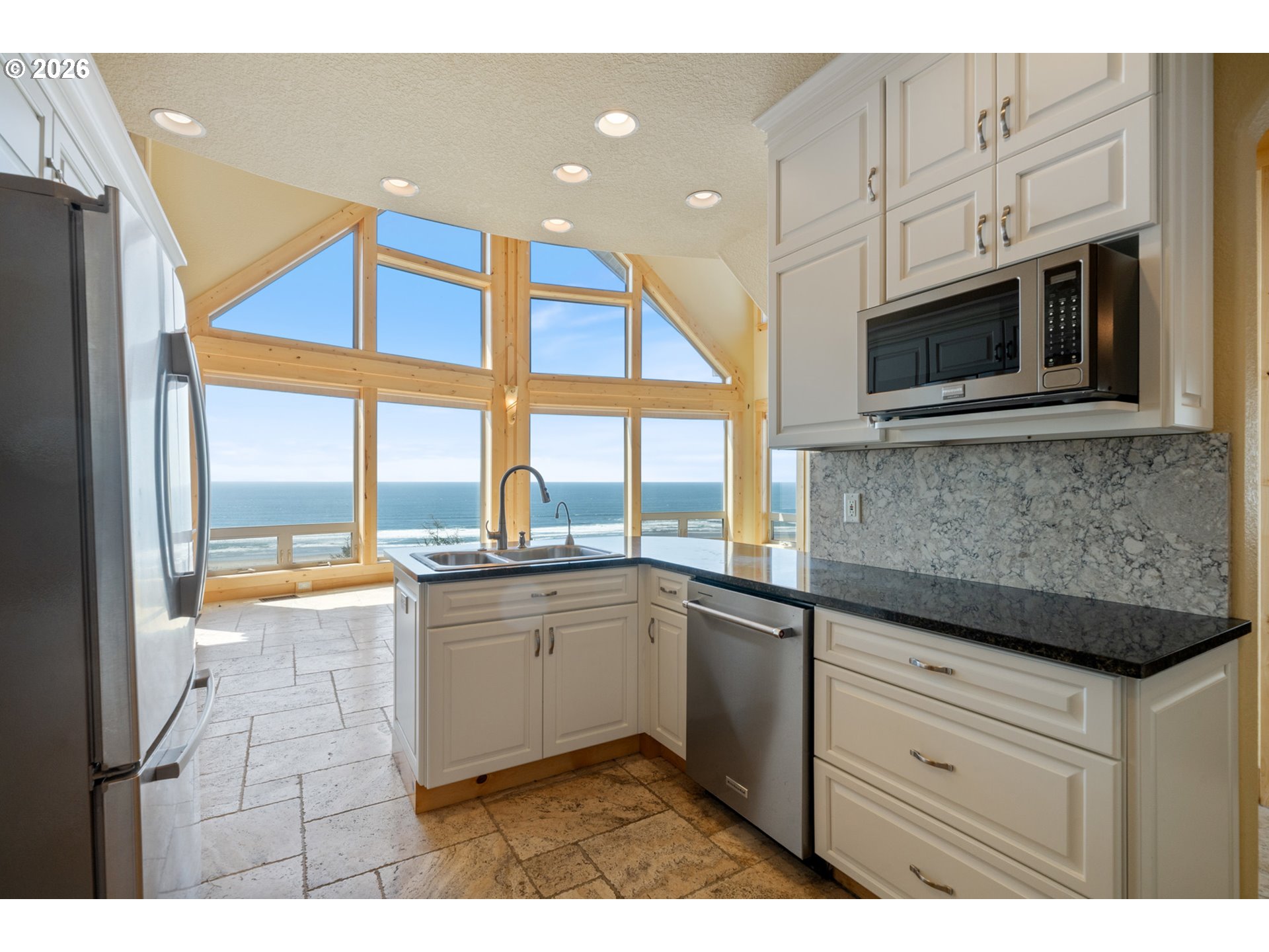367 South Longview Loop Rockaway Beach, OR 97136 - Photo 12 of 48 a kitchen with stainless steel appliances granite countertop a sink and a microwave