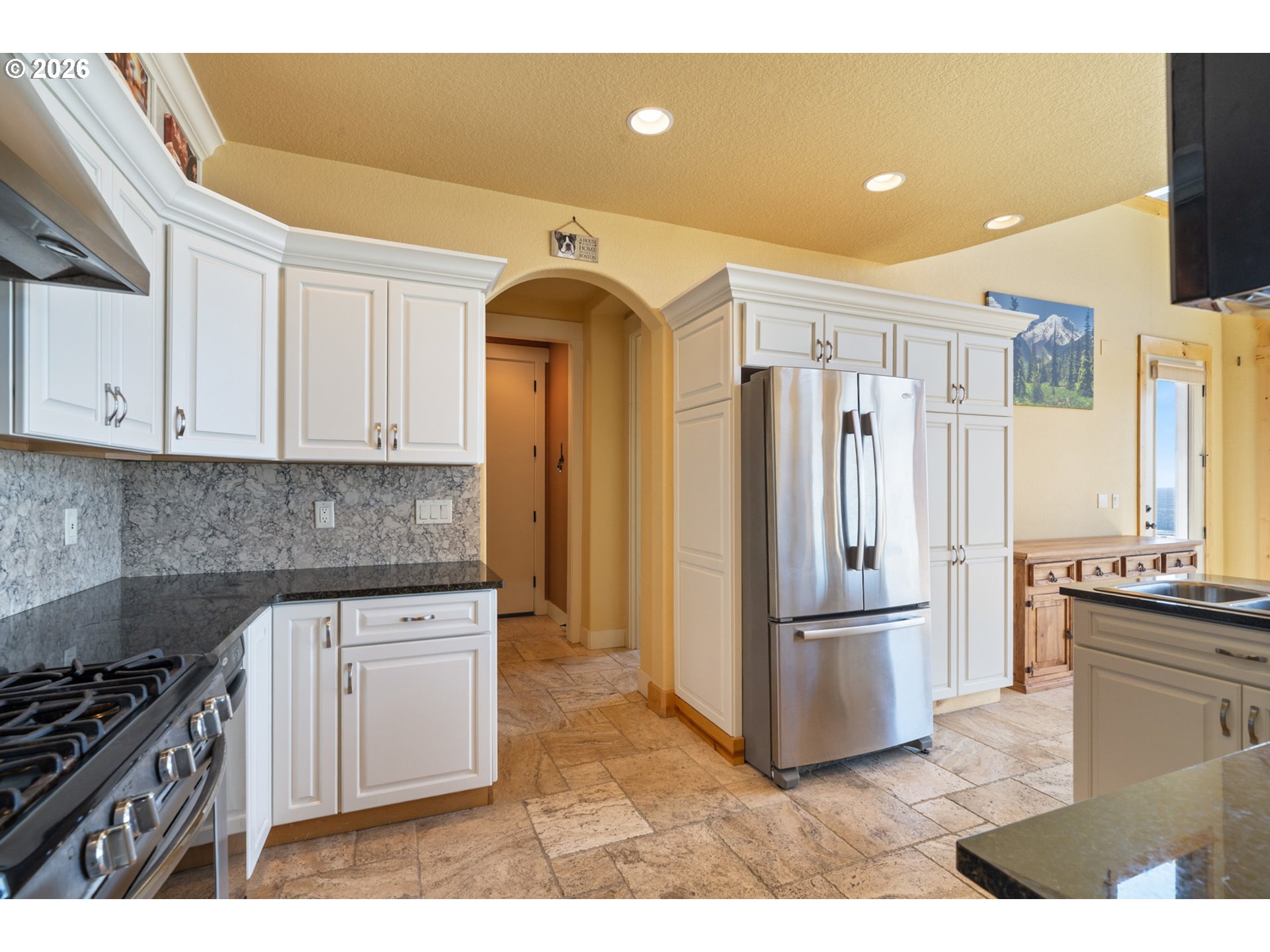 367 South Longview Loop Rockaway Beach, OR 97136 - Photo 14 of 48 a kitchen with granite countertop a refrigerator and a stove top oven