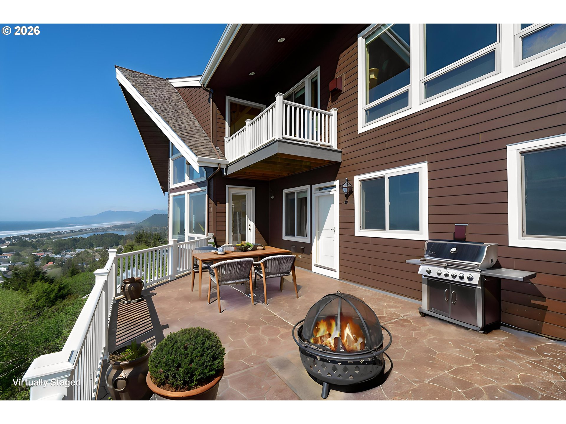 367 South Longview Loop Rockaway Beach, OR 97136 - Photo 15 of 48 a view of a patio with table and chairs with wooden floor