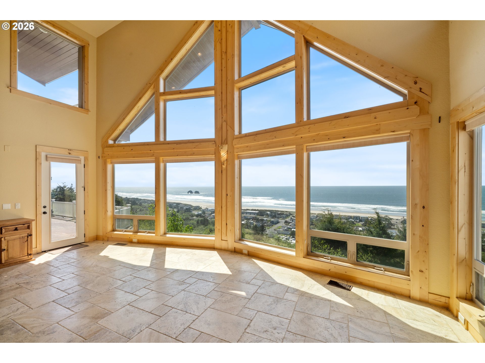 367 South Longview Loop Rockaway Beach, OR 97136 - Photo 2 of 48 a view of an empty room with wooden floor and a window