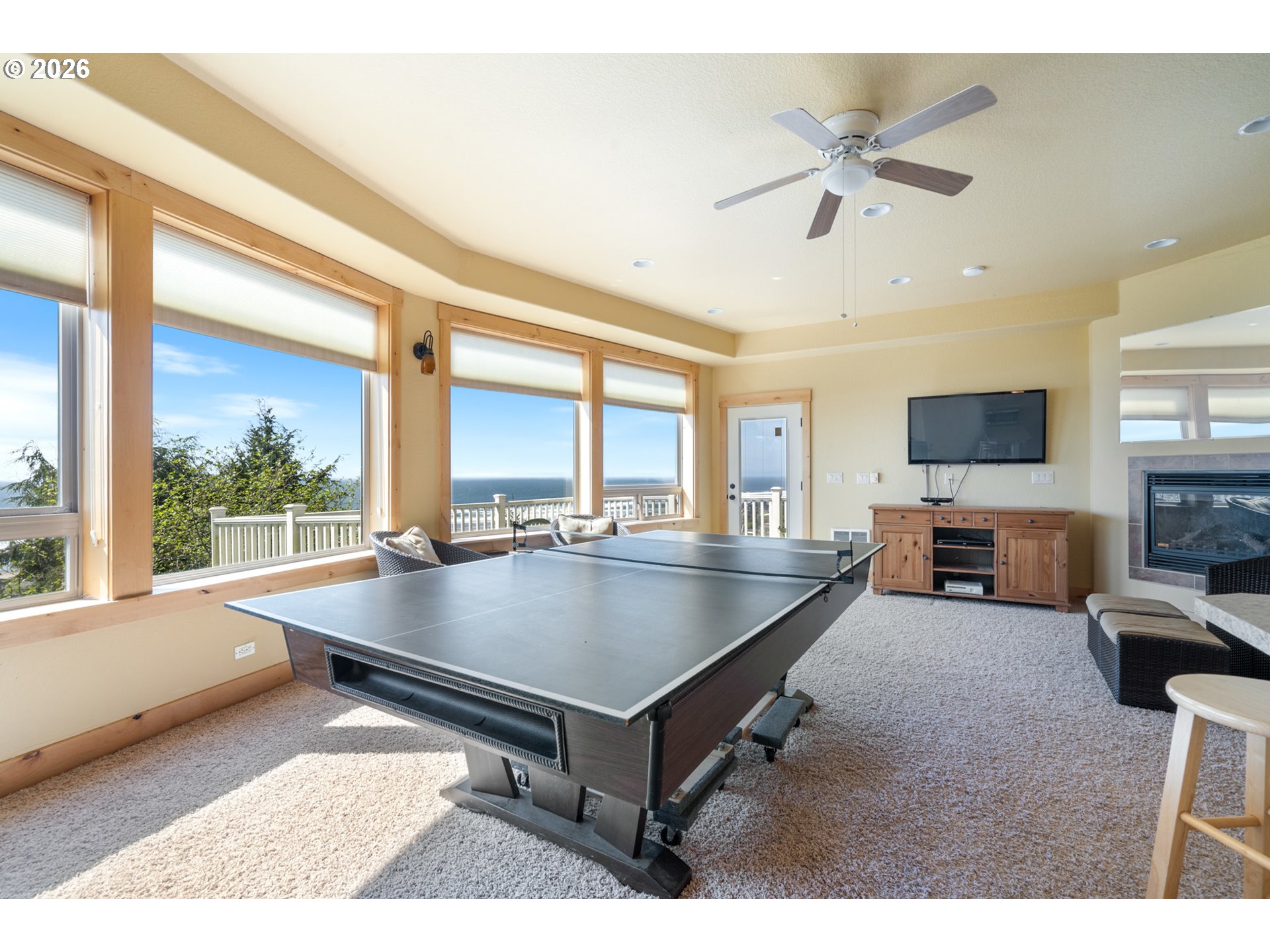 367 South Longview Loop Rockaway Beach, OR 97136 - Photo 39 of 48 a living room with couches a table and a large window with garden view