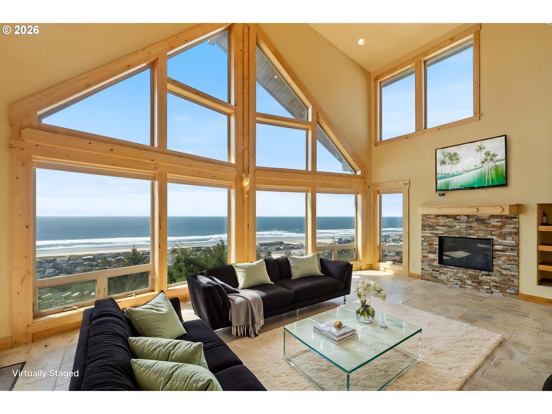 367 South Longview Loop Rockaway Beach, OR 97136 - Photo 7 of 48 a living room with furniture a fireplace and floor to ceiling windows
