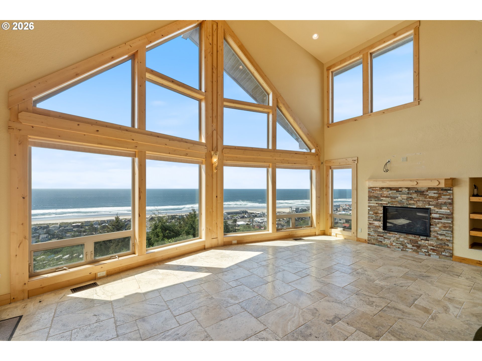 367 South Longview Loop Rockaway Beach, OR 97136 - Photo 8 of 48 a view of an empty room with a fireplace and a large window