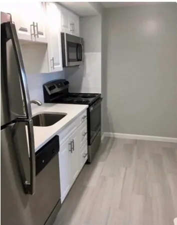 a kitchen with a sink and refrigerator