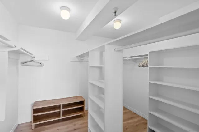 a view of walk in closet with empty racks