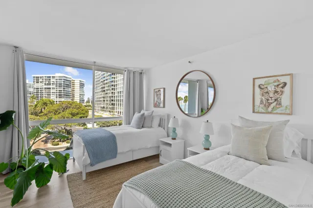a bedroom with bed and a large window with outer view