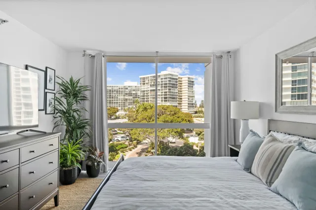 a bed sitting in a bedroom next to a window