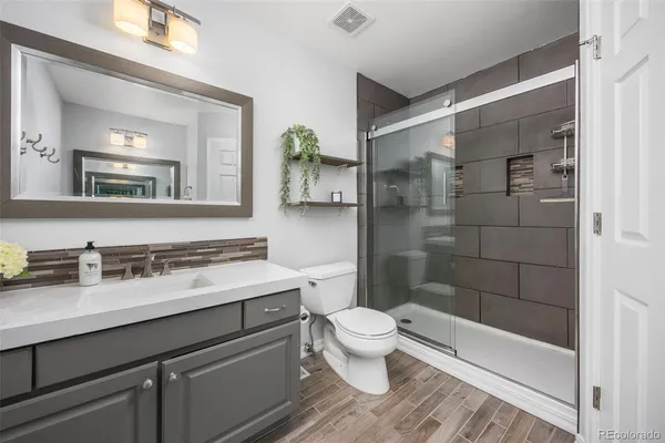 a bathroom with a sink toilet and shower