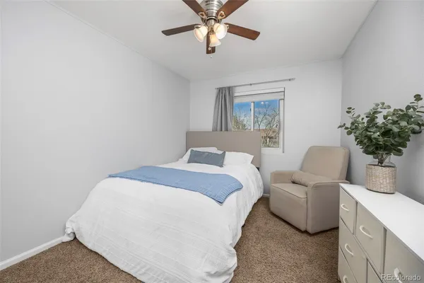 a bedroom with a bed and ceiling fan