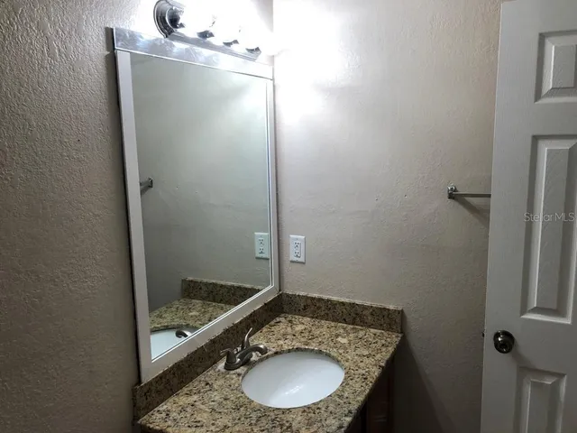 a bathroom with a sink and a mirror