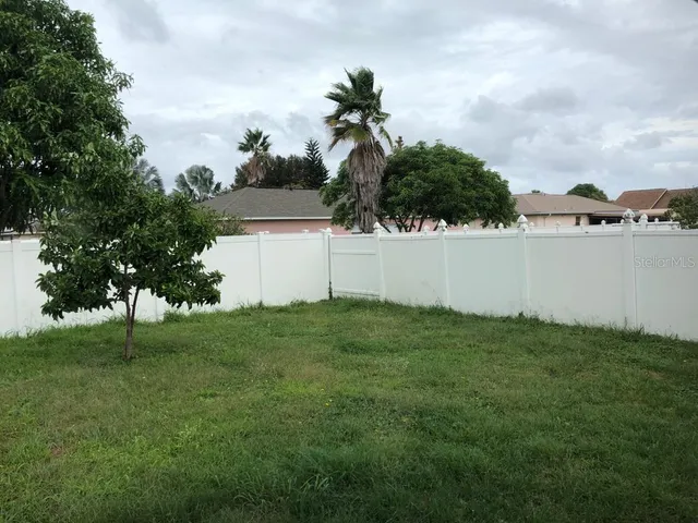 a view of small house with yard