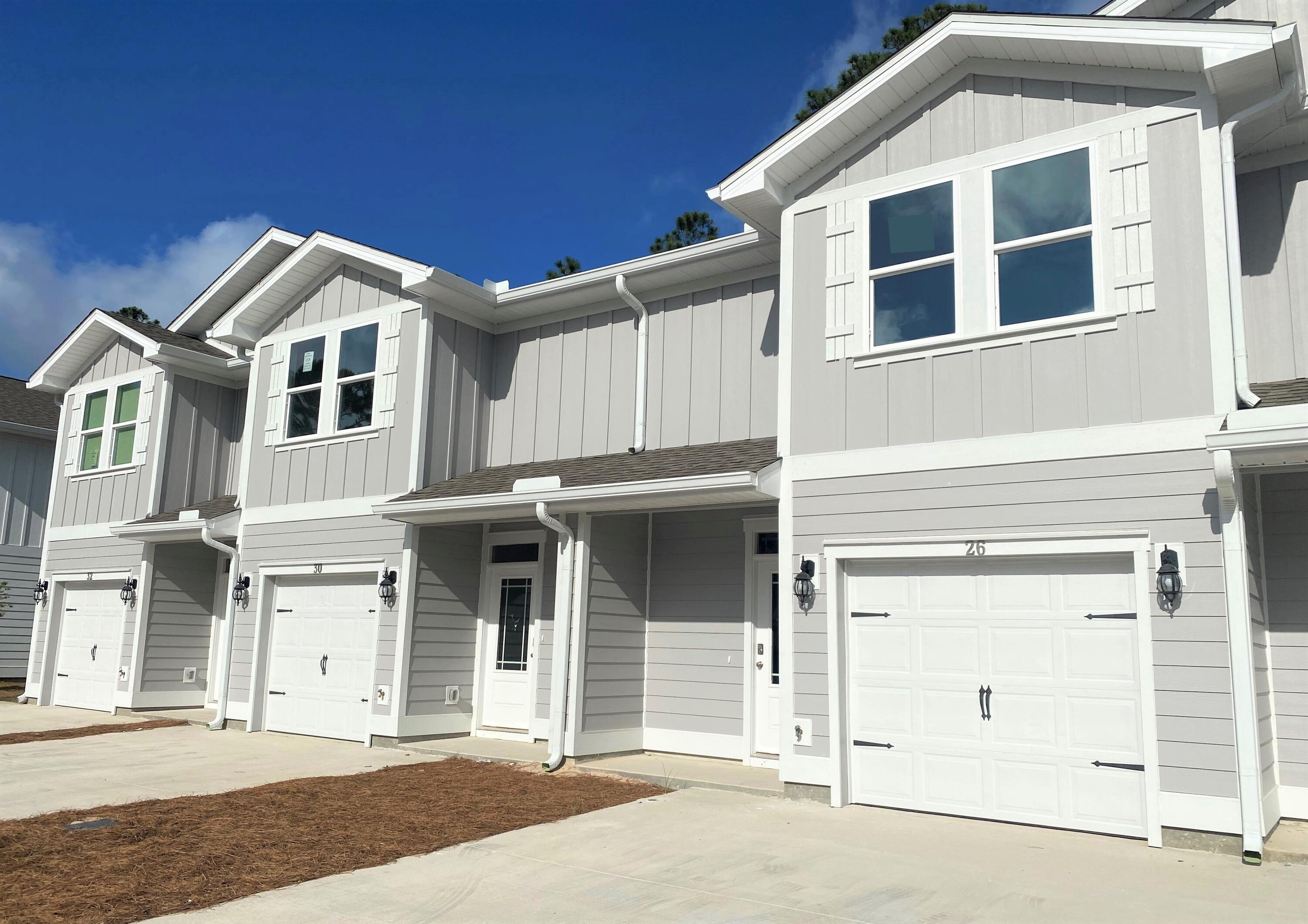 2 Renea Cove, Unit LOT 009 Destin, FL 32541 - Photo 1 of 30 a front view of a house with a garage