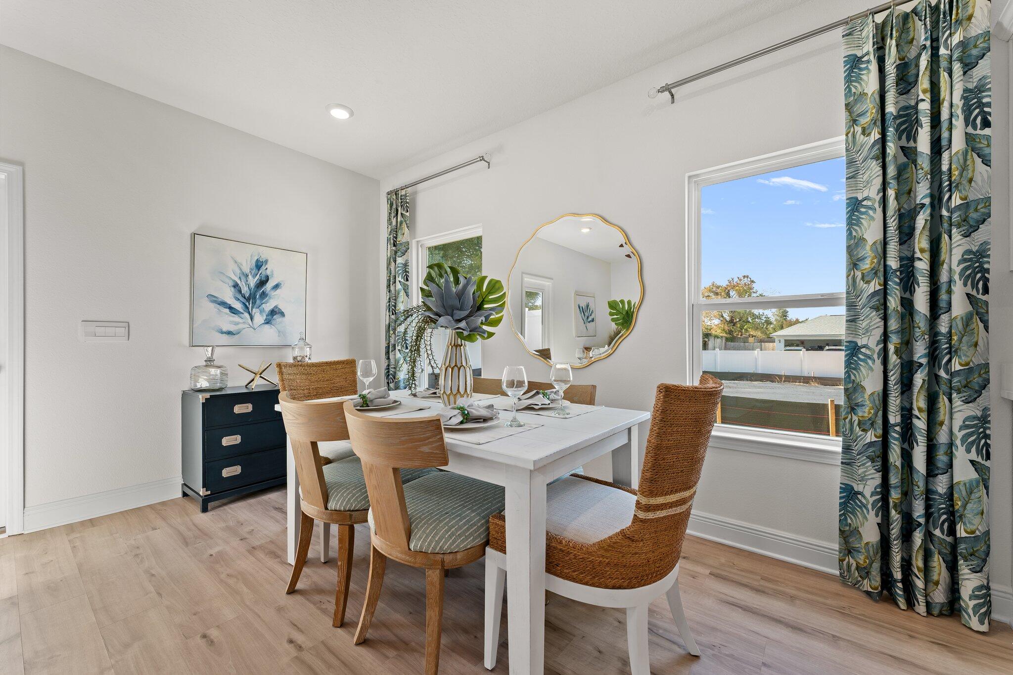 2 Renea Cove, Unit LOT 009 Destin, FL 32541 - Photo 15 of 30 a dining room with furniture a window and wooden floor