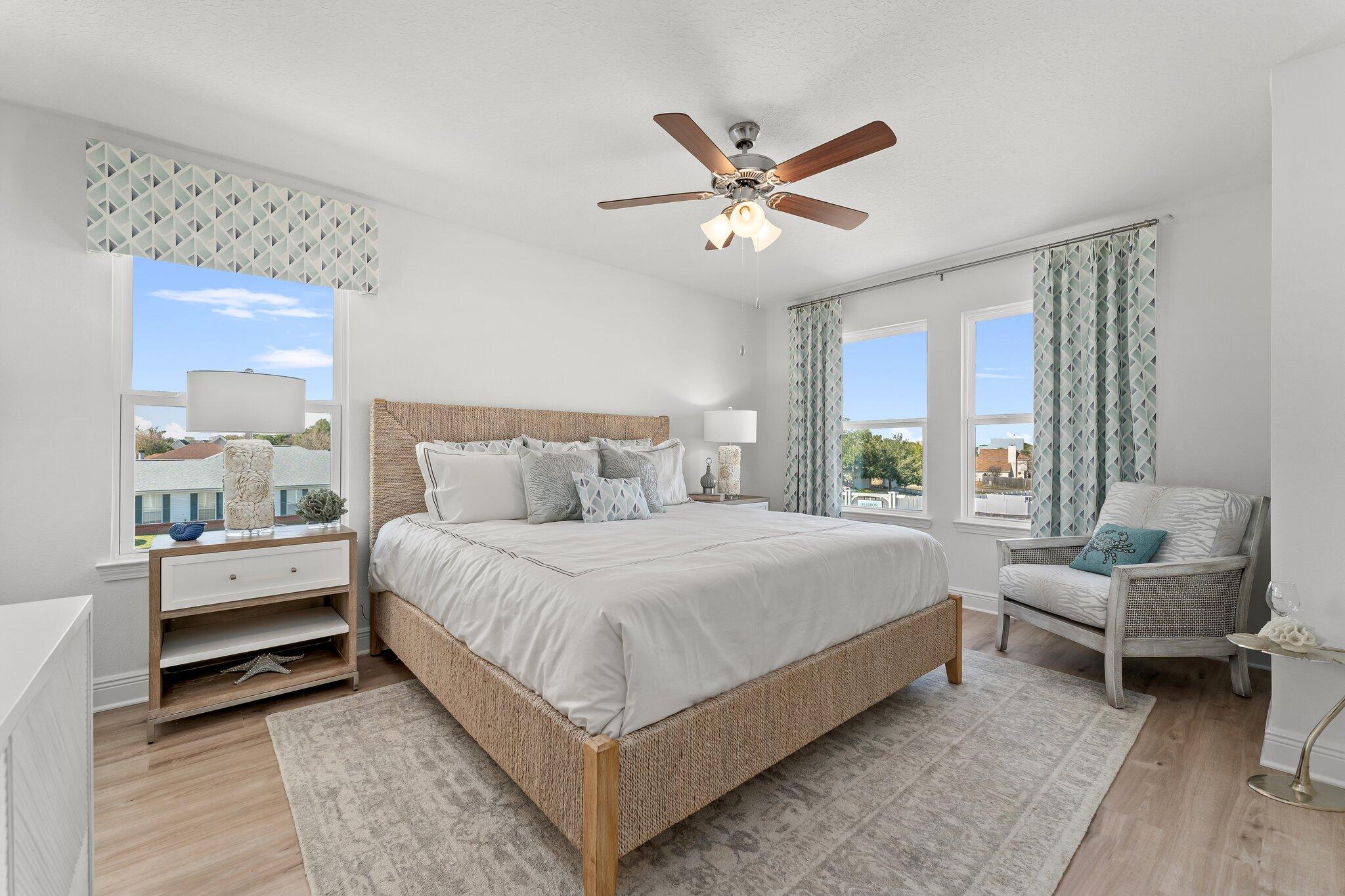 2 Renea Cove, Unit LOT 009 Destin, FL 32541 - Photo 18 of 30 a bedroom with a bed and a chandelier