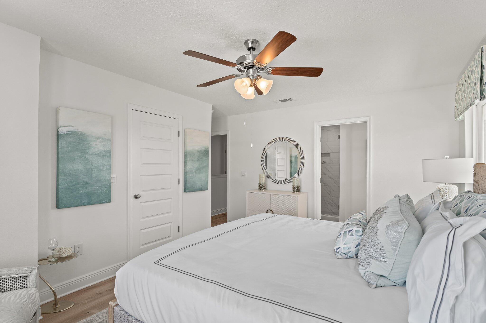 2 Renea Cove, Unit LOT 009 Destin, FL 32541 - Photo 22 of 30 a bedroom with a bed and a chandelier