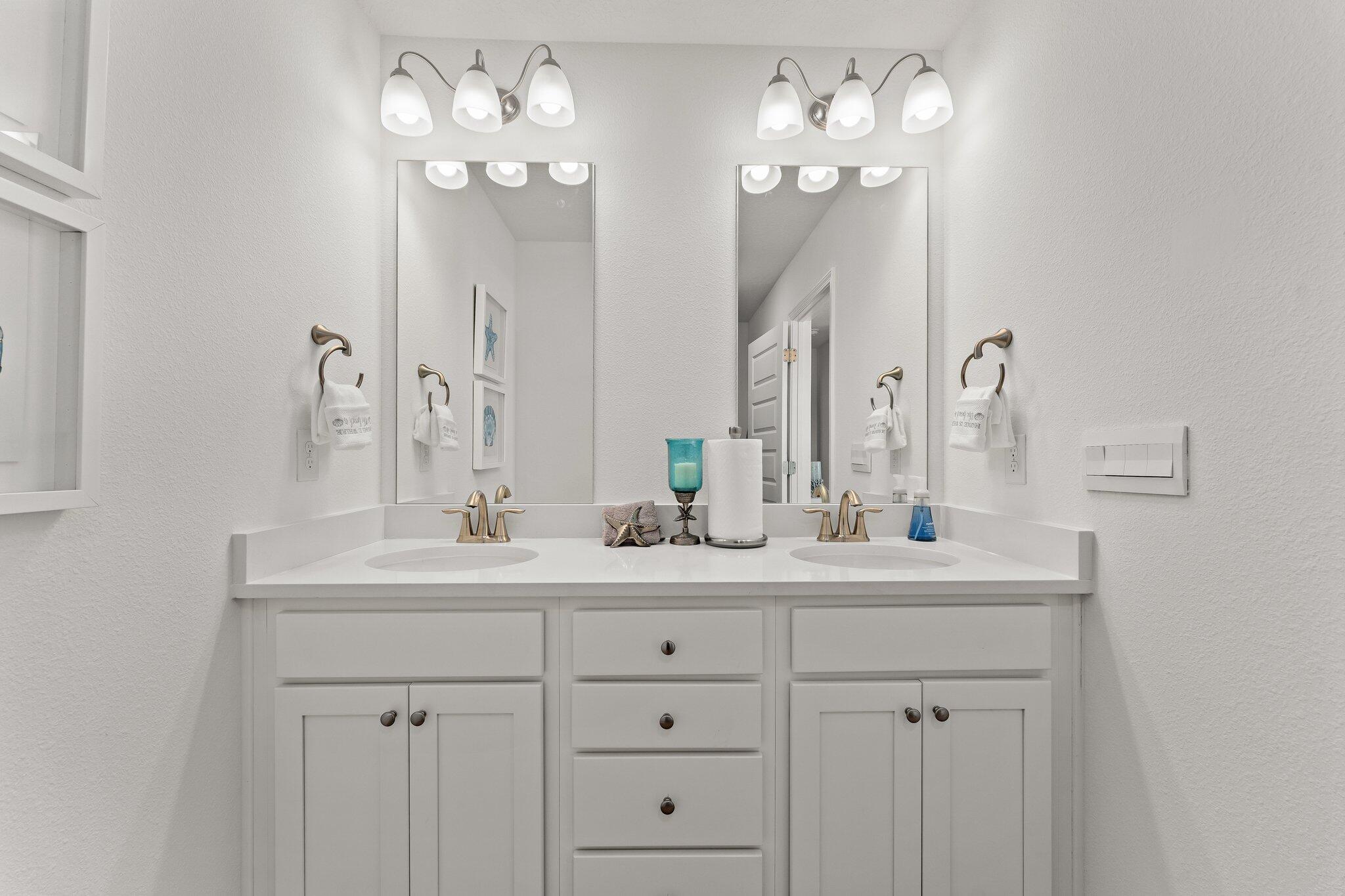 2 Renea Cove, Unit LOT 009 Destin, FL 32541 - Photo 26 of 30 a bathroom with double vanity sinks a vanity a lamp and a mirror