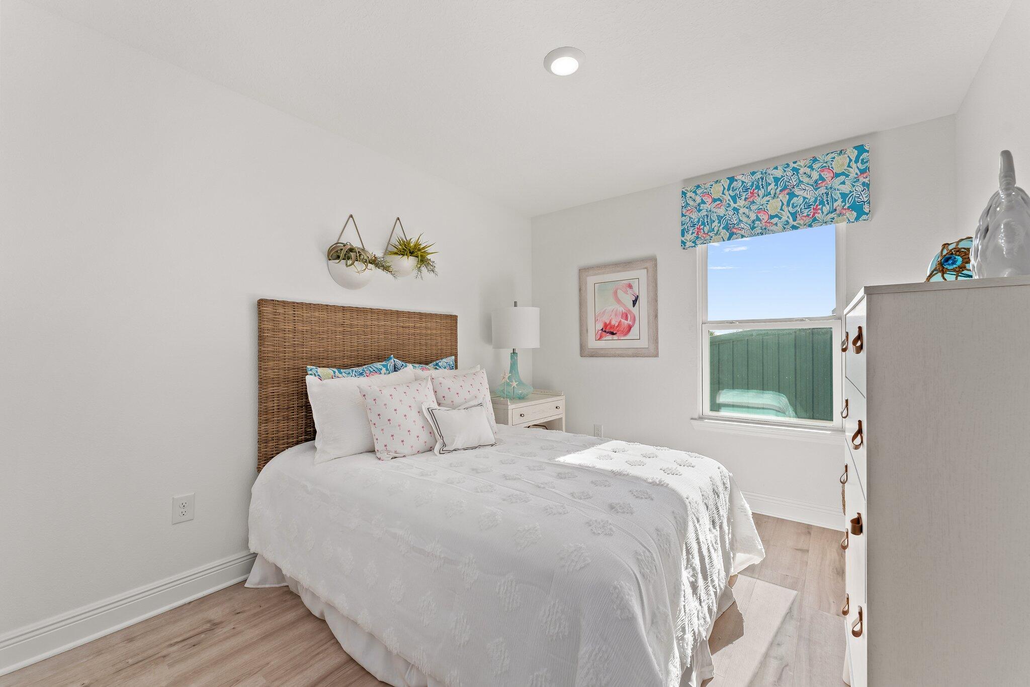 2 Renea Cove, Unit LOT 009 Destin, FL 32541 - Photo 28 of 30 a bedroom with a bed a window and a wooden floor
