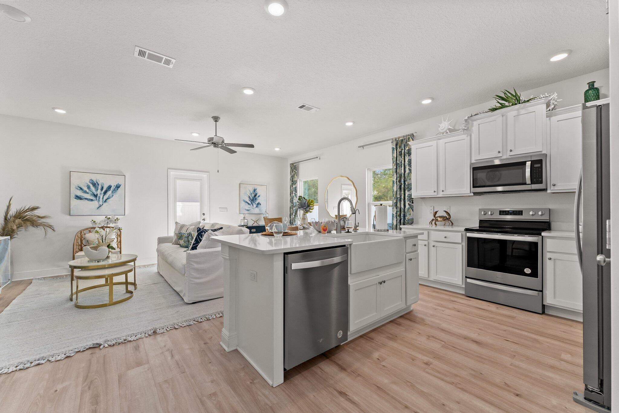 2 Renea Cove, Unit LOT 009 Destin, FL 32541 - Photo 5 of 30 a kitchen with stainless steel appliances kitchen island granite countertop a stove a sink and a refrigerator