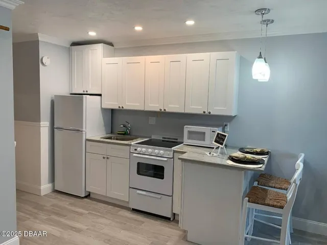 a kitchen with a stove sink and refrigerator