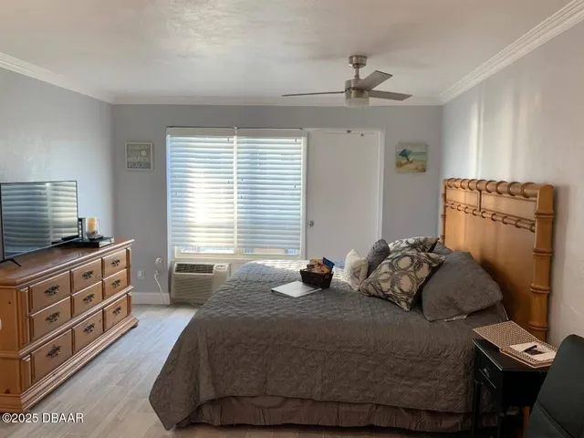 a bedroom with a bed and a dresser in it