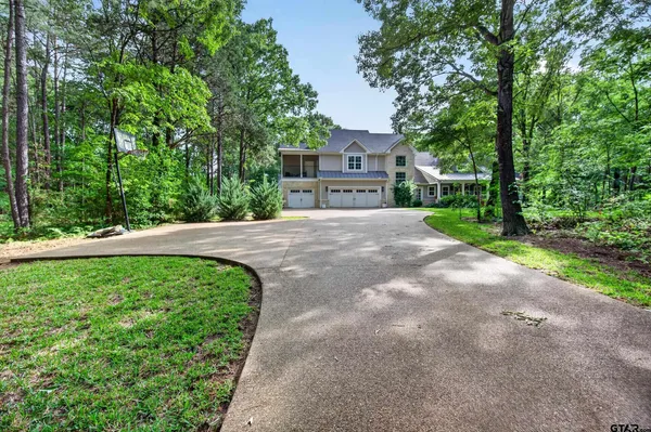 a pathway of a house with a yard