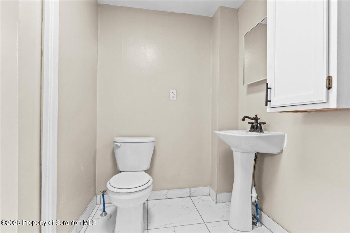 132 Penn Avenue Exeter, PA 18643 - Photo 11 of 44 a bathroom with a toilet sink and mirror