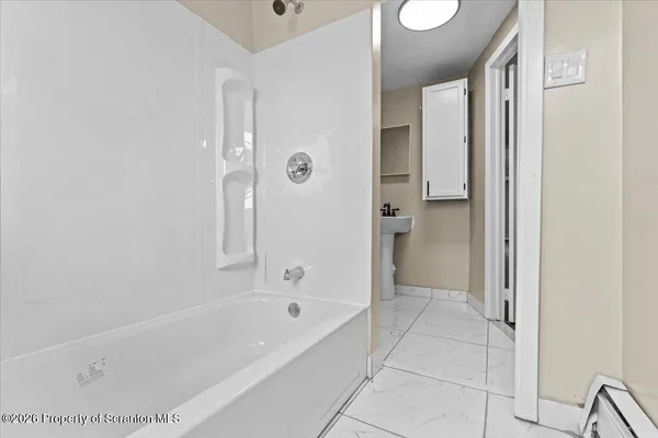 a white bath tub sitting next to a window