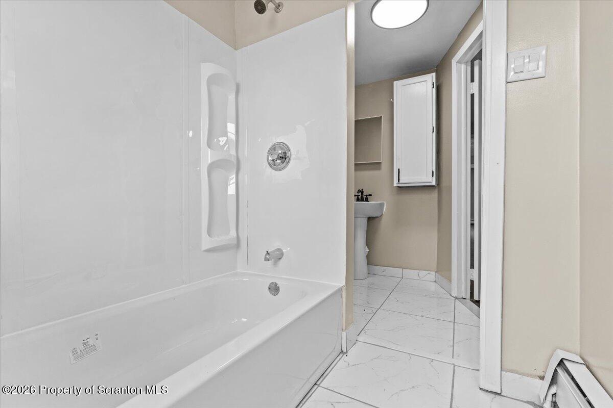 132 Penn Avenue Exeter, PA 18643 - Photo 12 of 44 a bathroom with a bathtub and a shower