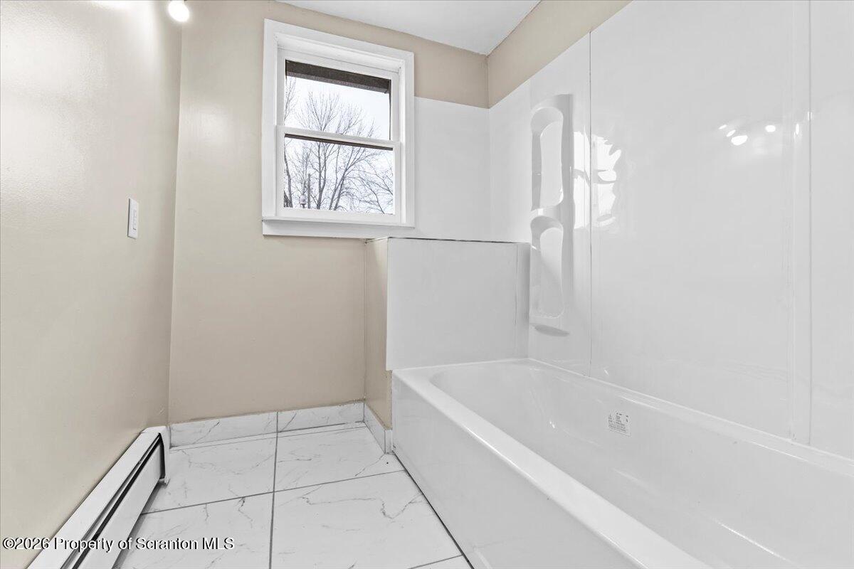 132 Penn Avenue Exeter, PA 18643 - Photo 13 of 44 a white bath tub sitting next to a window