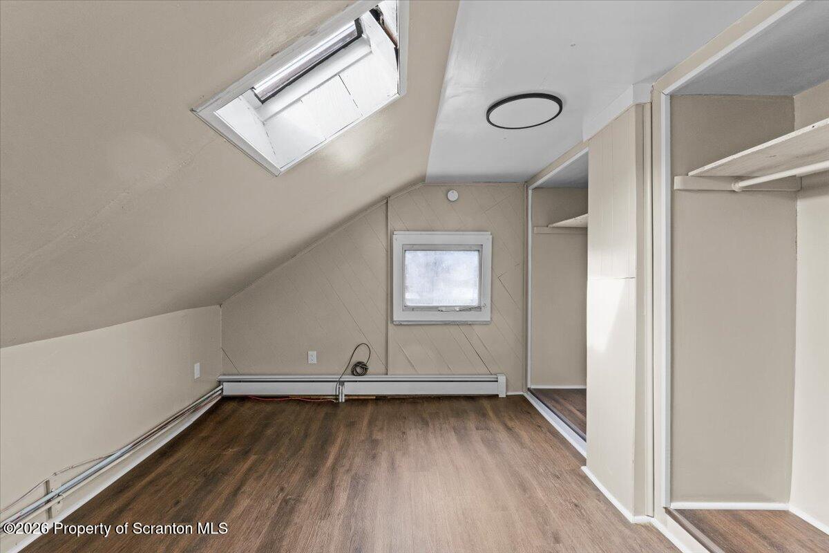 132 Penn Avenue Exeter, PA 18643 - Photo 14 of 44 an empty room with wooden floor and windows