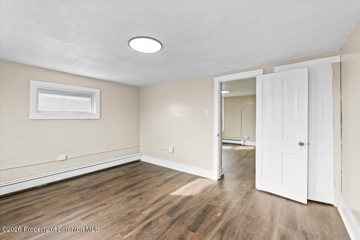 132 Penn Avenue Exeter, PA 18643 - Photo 19 of 44 an empty room with wooden floor and windows