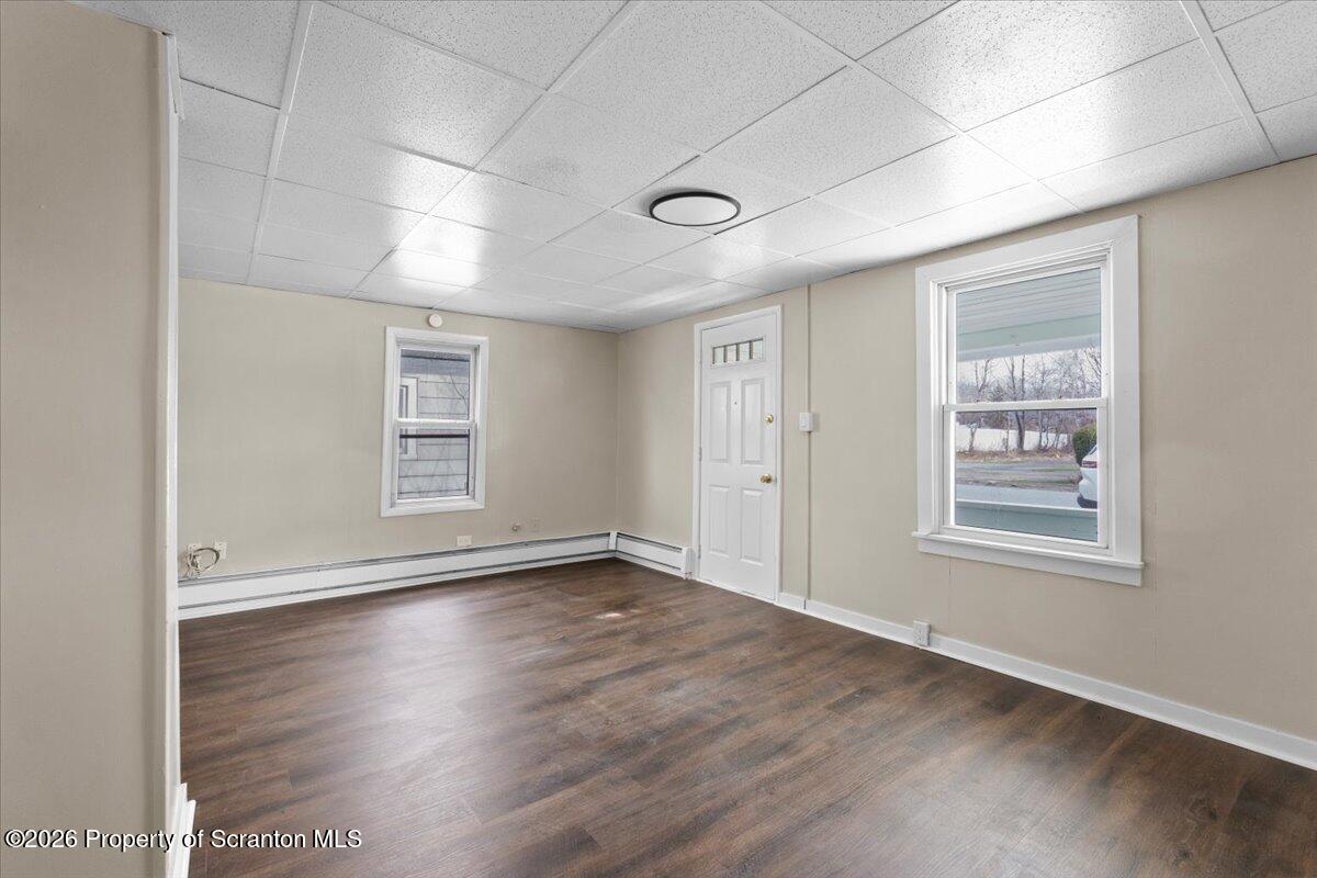 132 Penn Avenue Exeter, PA 18643 - Photo 21 of 44 an empty room with wooden floor and windows