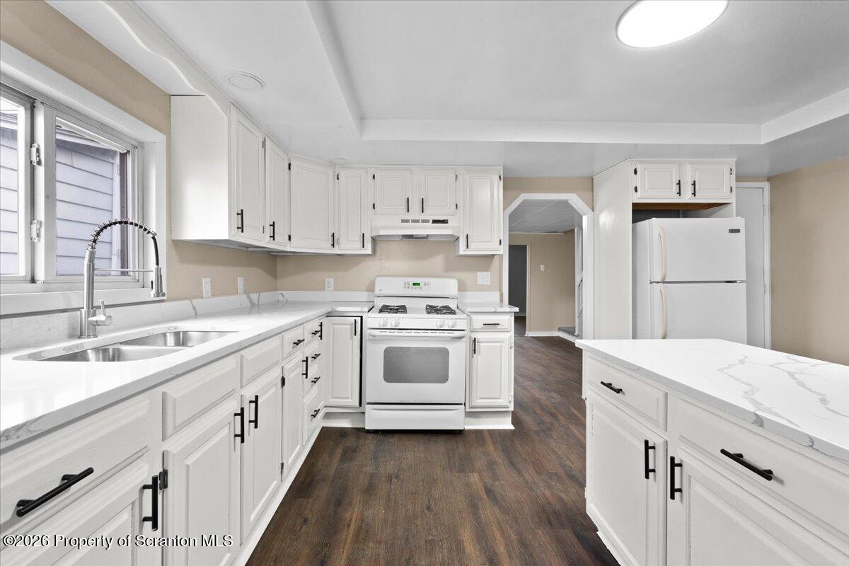 132 Penn Avenue Exeter, PA 18643 - Photo 27 of 44 a kitchen with white cabinets and white appliances