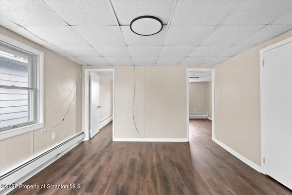 a view of room with window and wooden floor