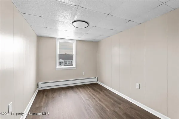 a view of a room with wooden floor and glass doors