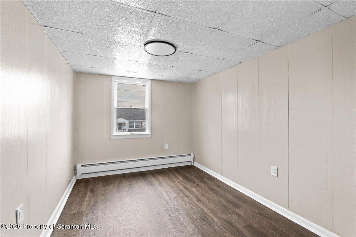 132 Penn Avenue Exeter, PA 18643 - Photo 34 of 44 an empty room with wooden floor and windows