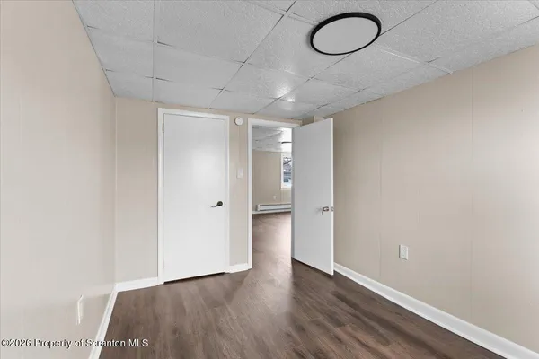 a view of a room with wooden floor and window