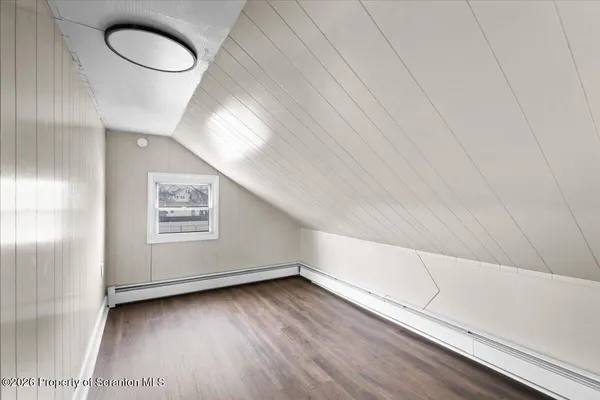 a view of hallway with wooden floor