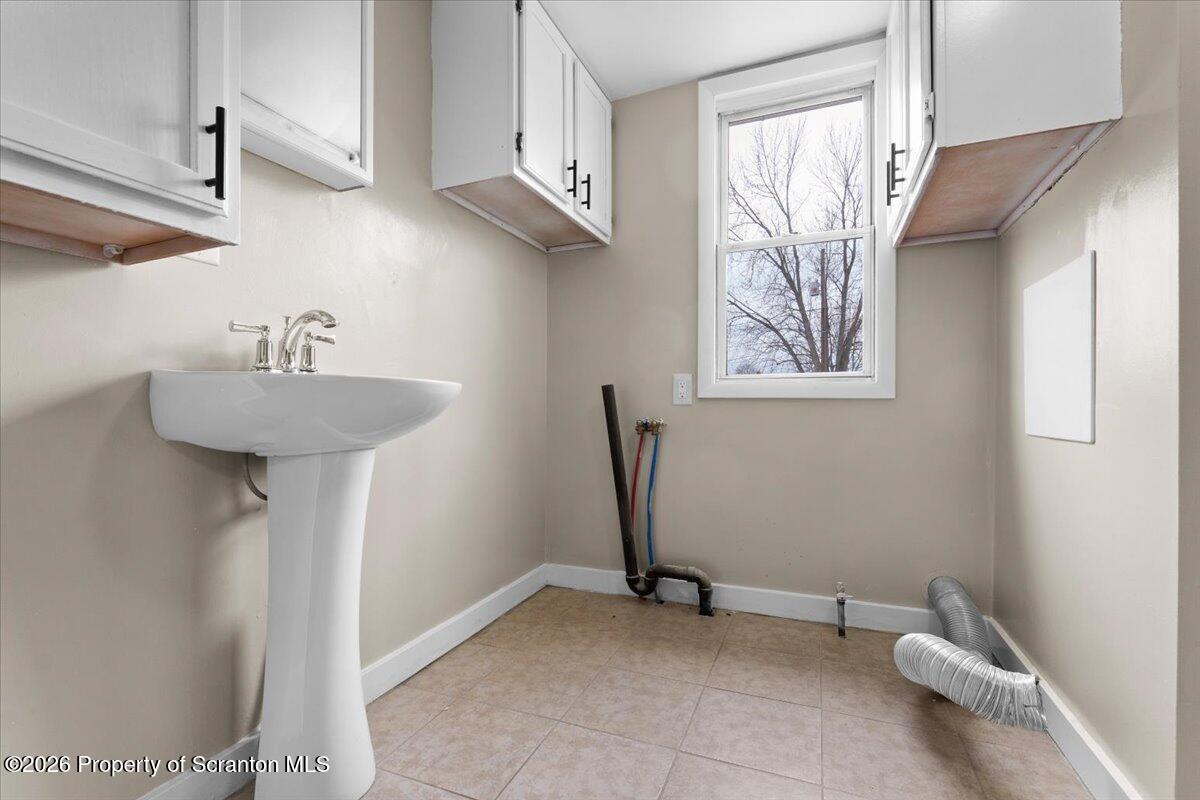 132 Penn Avenue Exeter, PA 18643 - Photo 38 of 44 a bathroom with a sink a window and a mirror