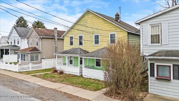a view of a house with a yard and lawn chairs